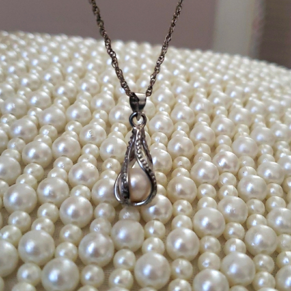 Pearl and silver cage necklace